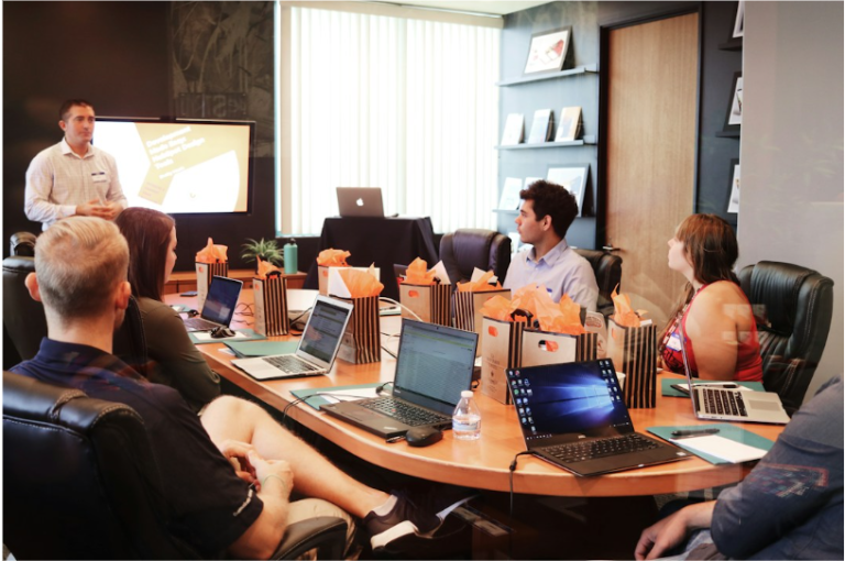 A team in an office discussing telecom expense management during a meeting