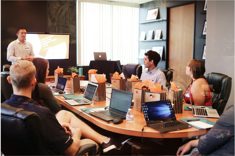 A team in an office discussing telecom expense management during a meeting